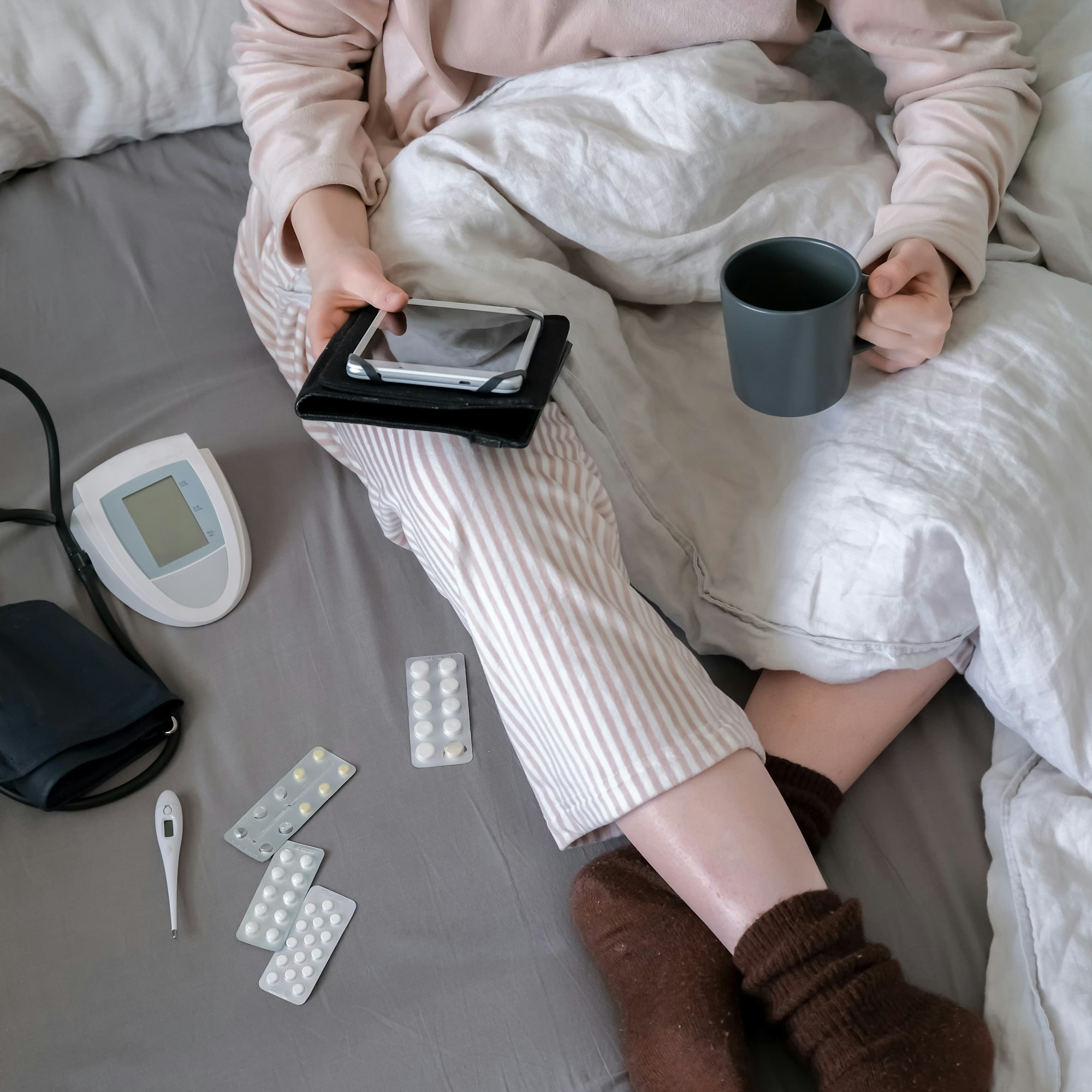Medicine. The girl is sick at home in bed, next to pills, thermometer, medicines. Virus and